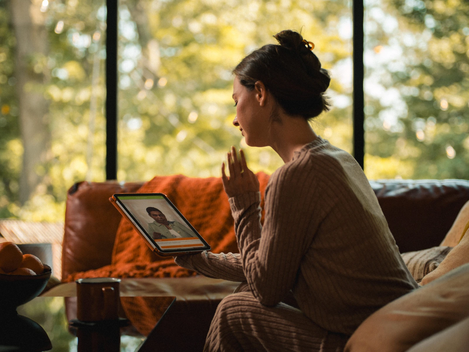 A woman practices a Xuron virtual-patient conversation on an iPad.