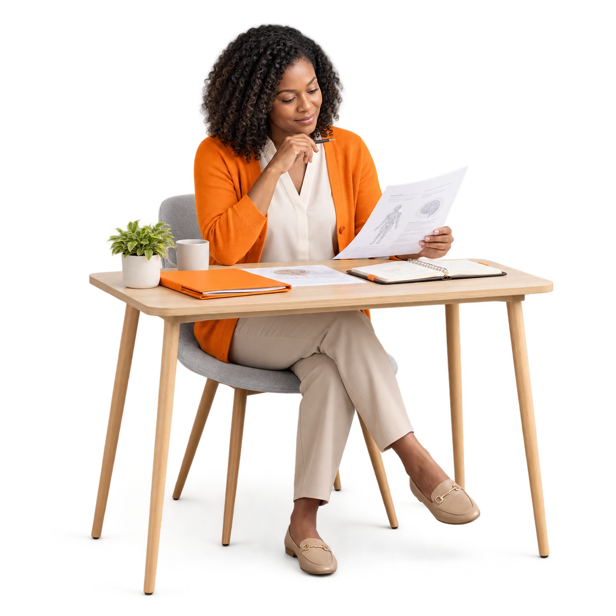 An educator reviewing training materials at a desk.